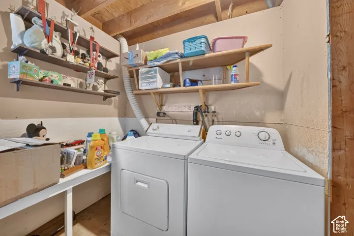 Laundry area featuring built-in wooden shelving and a dedicated folding surface