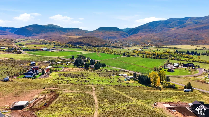 Expansive rural acreage featuring rolling topography, open pastureland, and prominent mountain backdrop