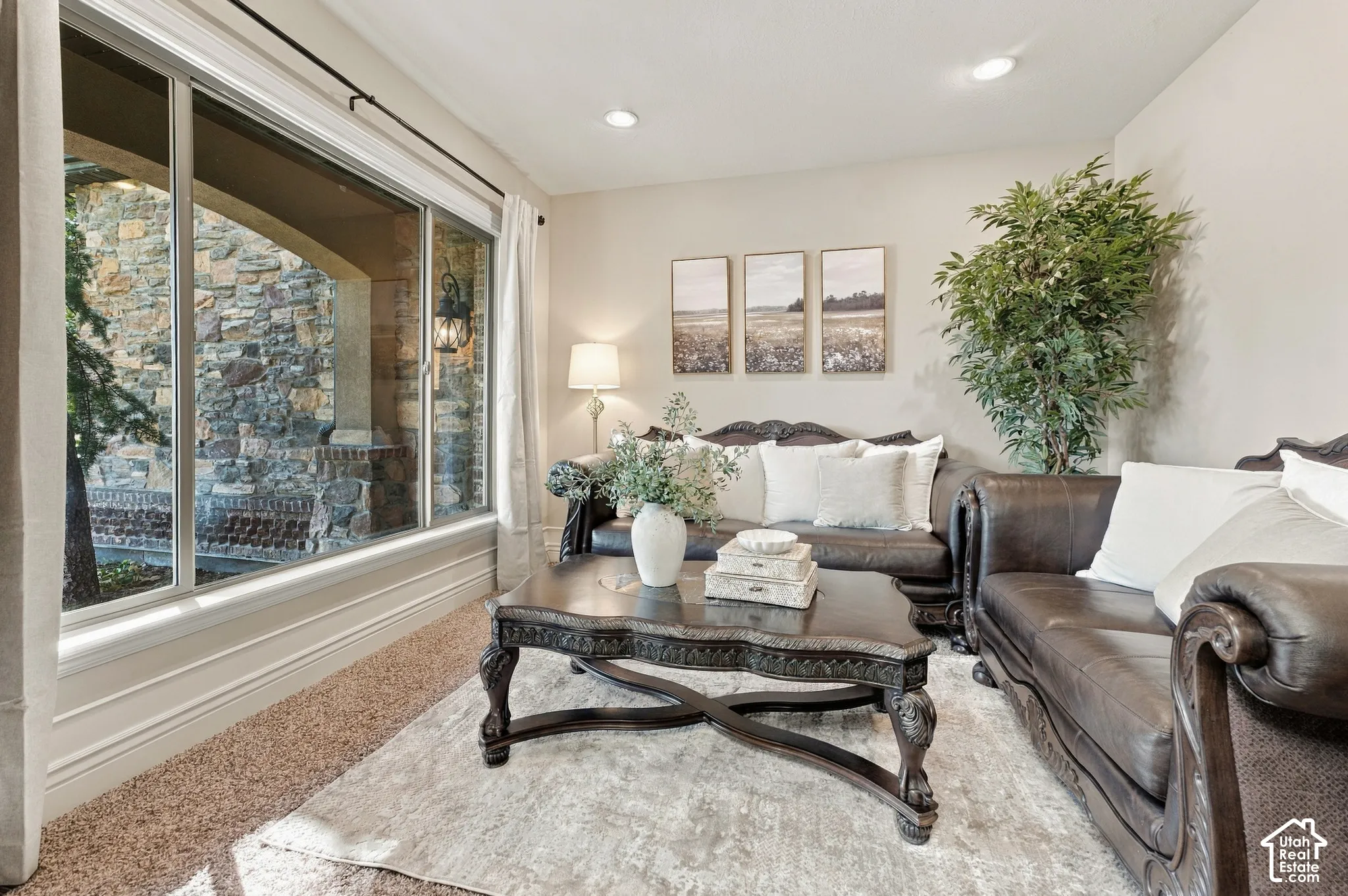 Large window with exterior stone masonry detail, recessed ceiling lighting, and carpeted flooring.