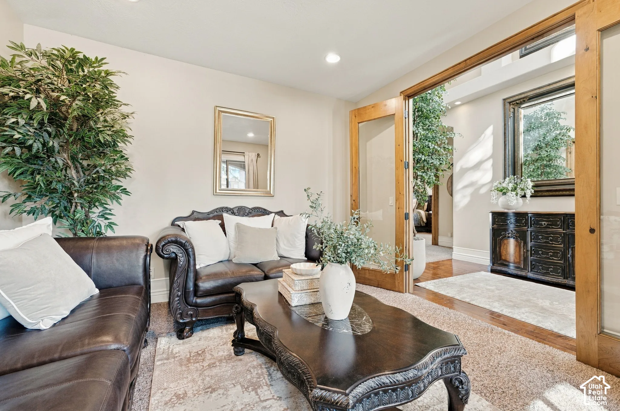 Double wood-framed glass-paneled doors featuring recessed lighting and neutral-toned wall paint.