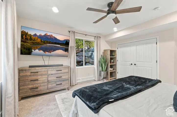 Room featuring neutral wall tones, a ceiling fan with integrated lighting, recessed lighting, and white paneled double closet doors.