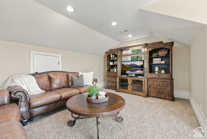 Vaulted ceilings featuring recessed lighting.
