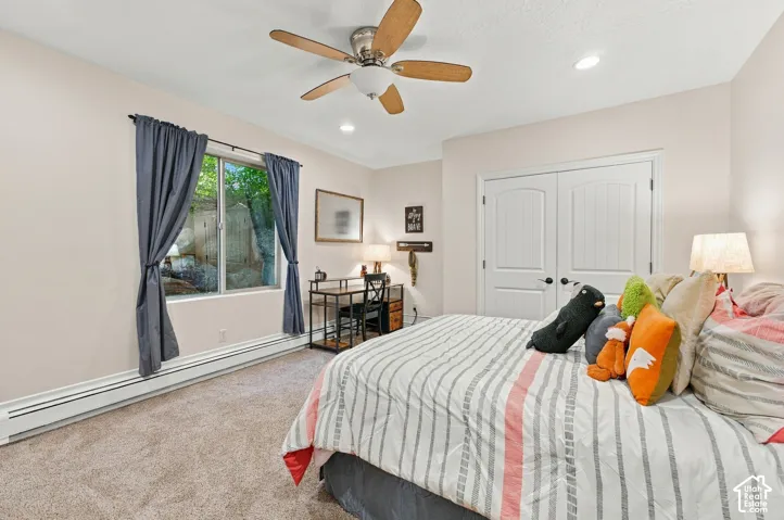 Bedroom featuring neutral wall paint, recessed lighting, a ceiling fan with light fixture, and double-door closet entry.