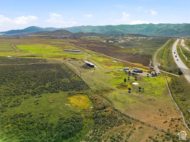 Expansive acreage featuring rolling terrain, established pastoral landscape, and mountain backdrops