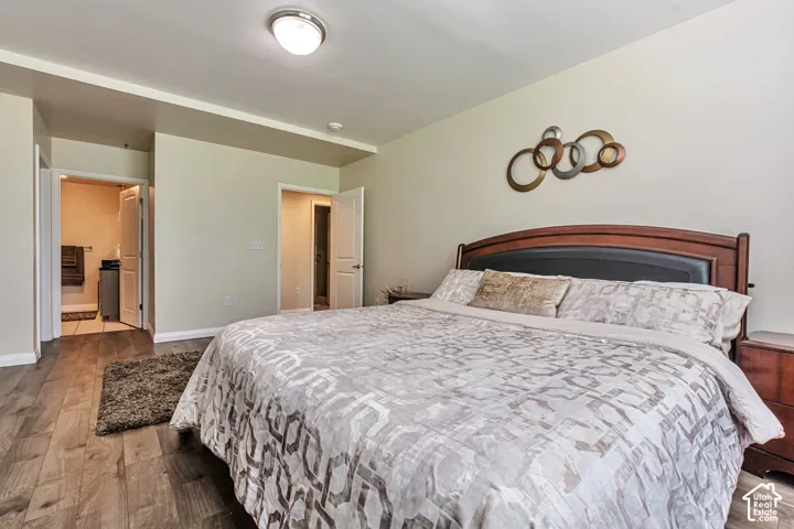 Wood-finish flooring, neutral wall tones, and recessed ceiling lighting