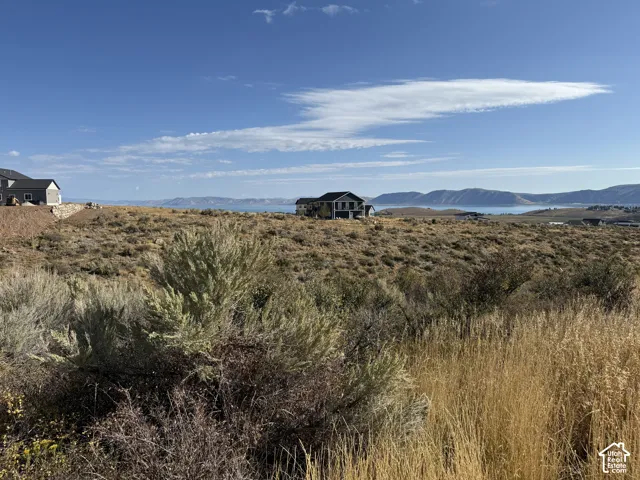 Expansive lot featuring native high-desert vegetation, rolling topography, and prominent mountain and lake scenery