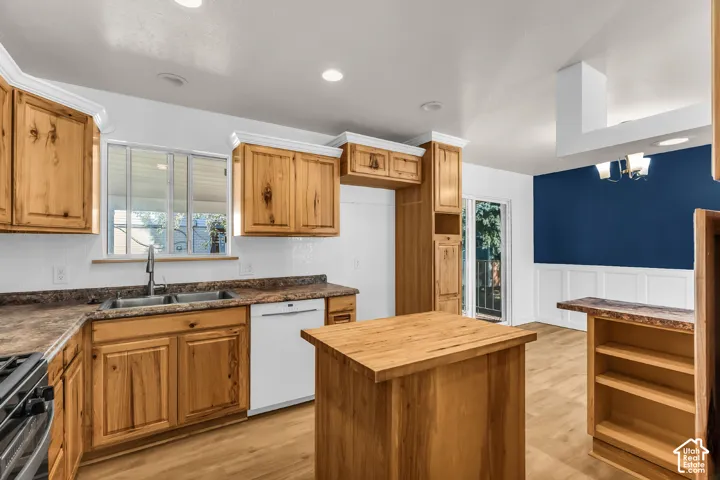 Kitchen featuring natural wood cabinetry, a center island with a wood countertop, wood-finish flooring, recessed lighting, and a dual-basin stainless steel sink