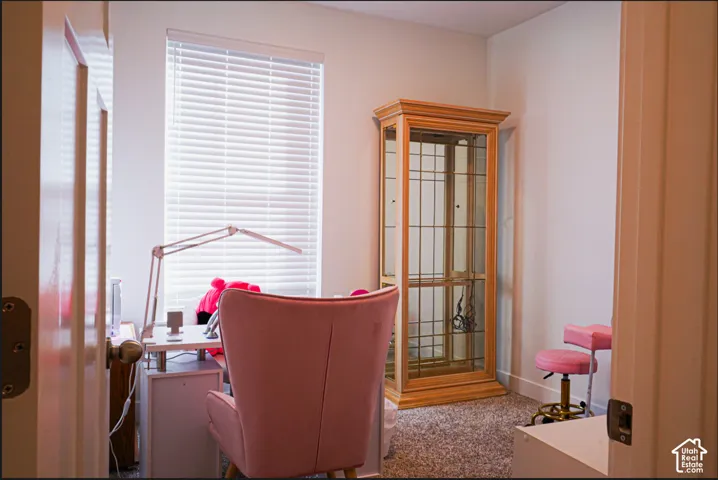 Room featuring wall-to-wall carpeting and a window equipped with horizontal blinds