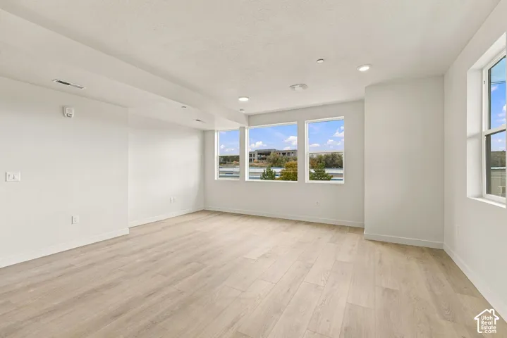 Interior space featuring light wood-finish flooring, recessed lighting, and expansive windows