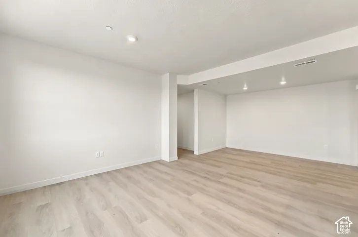 Interior space featuring wood-finish flooring, neutral walls, and recessed lighting