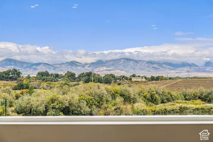 Expansive mountain backdrop, lush mature vegetation, and water frontage
