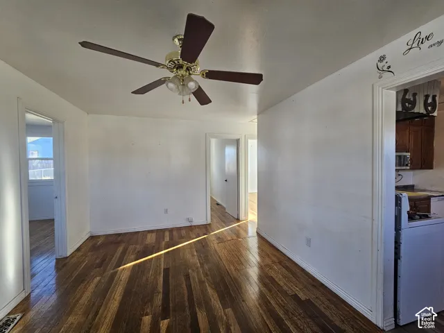 Hardwood flooring, central ceiling fan with integrated lighting, and multiple interior doorways