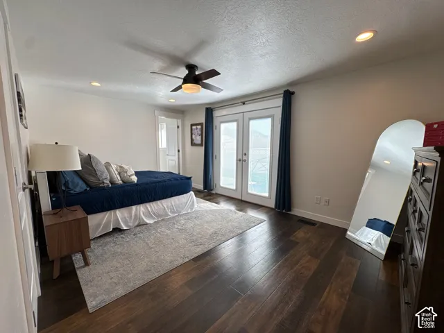 Bedroom featuring dark wood-finish flooring, recessed lighting, a ceiling fan, and glass-paned double doors