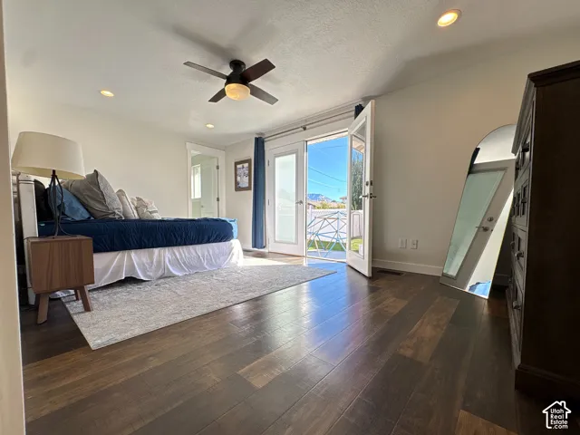 Wood-finish flooring, recessed lighting, ceiling fan with integrated light, and full-glass exterior door