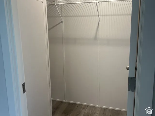 Closet featuring wood-finish flooring and white wire shelving