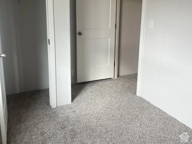 Bedroom 3Neutral wall finishes, textured carpeting, and two-panel interior doors