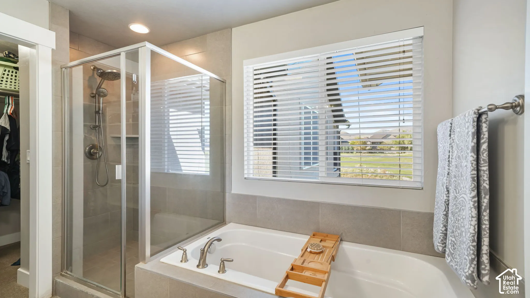 Primary bathroom with walk-in glass-enclosed shower, deep soaking tub