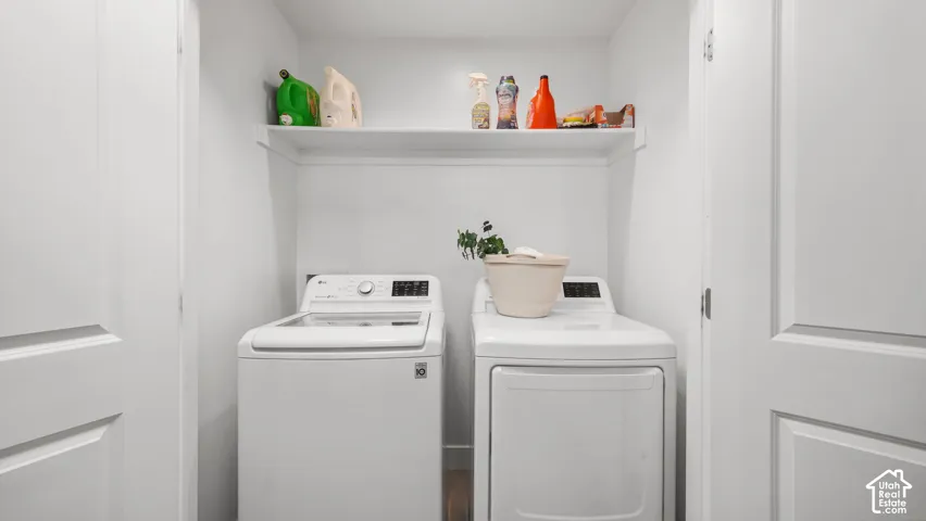 Laundry closet featuring dual panel doors and integrated overhead shelving