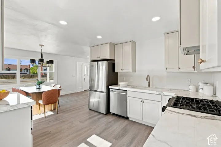 Kitchen featuring white cabinetry, stone-finish countertops, stainless steel appliances, recessed lighting, and wood-finish flooring