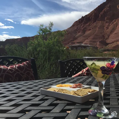 Outdoor patio featuring a metal latticework table and prominent mountain backdrop