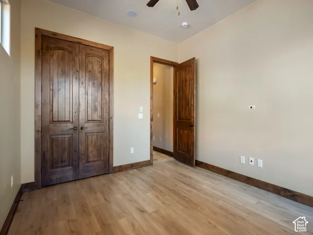 Wood-finish flooring, solid wood-core arched interior doors, and stained wood door casings