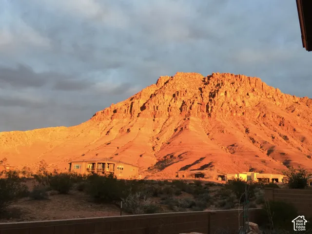 Rugged mountain backdrop with natural rock formations and desert landscaping