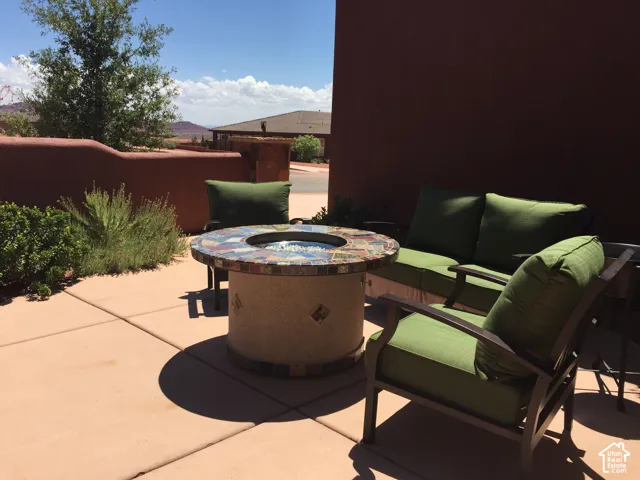 Concrete patio featuring a low-profile masonry perimeter wall and xeriscaped plantings