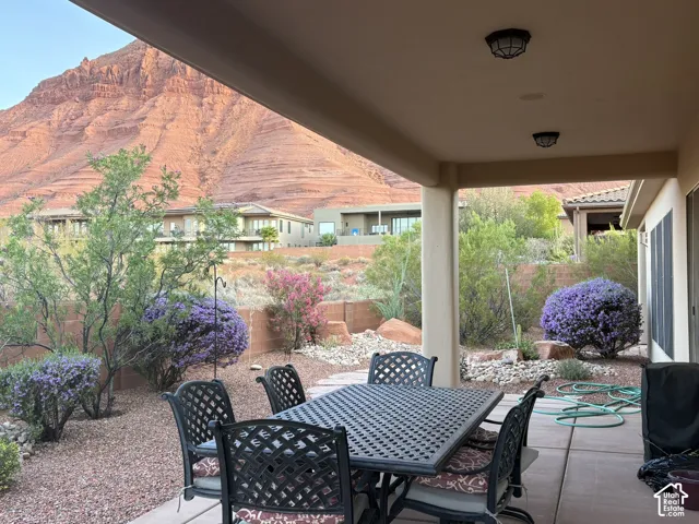 Covered patio featuring concrete flooring, recessed lighting, and prominent mountain backdrop