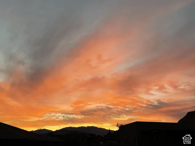 Mountain silhouette backdrop set against an expansive, colorful sky