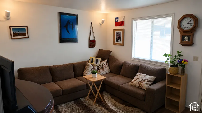 Single-pane window with white trim, wall-mounted adjustable light fixtures, and neutral interior wall finish
