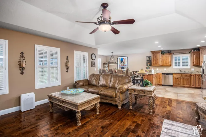 Vaulted ceilings, wood-finish flooring, plantation shutters, recessed lighting, and wooden cabinetry
