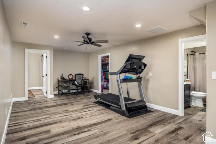 Multi-purpose room featuring wood-finish flooring, recessed lighting, and a ceiling fan
