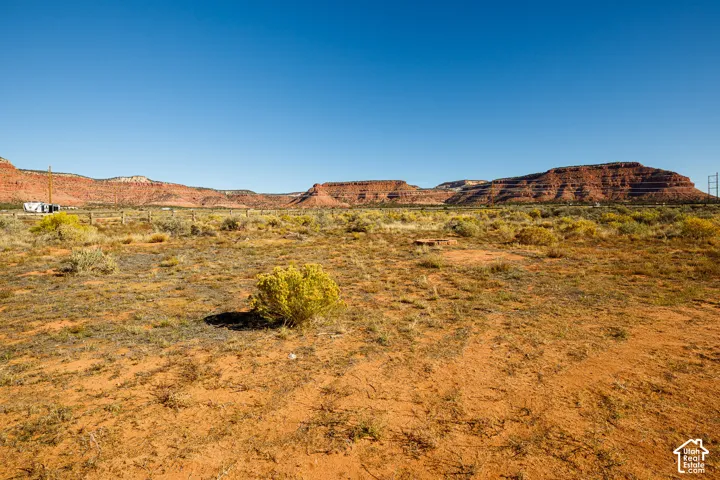 Expansive lot featuring desert terrain, native vegetation, and mesa backdrops