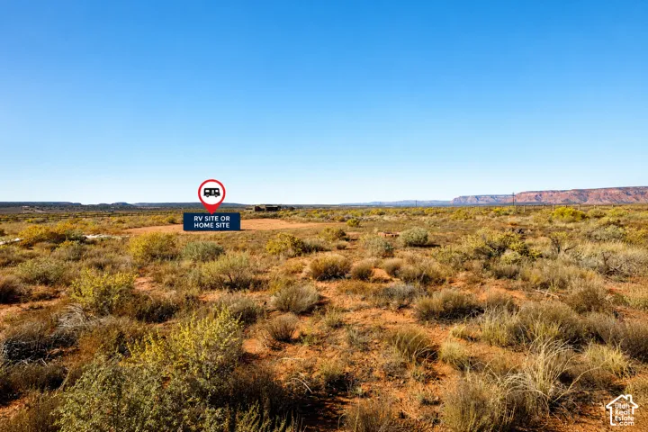 Expansive desert acreage featuring native vegetation and prominent mountain and mesa backdrops