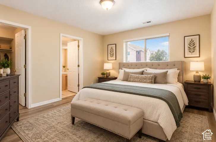Room featuring wood-finish flooring, a neutral color palette, and a dual-pane sliding window with integrated blinds