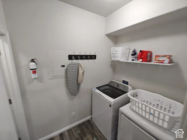 Utility area featuring wood-finish flooring, a wall-mounted hook rack, and an overhead shelf