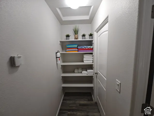 Built-in white shelving, wood-finish flooring, and a single-panel interior door