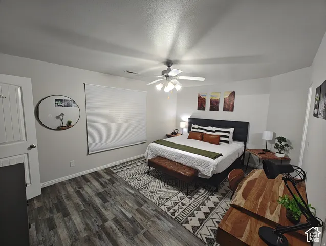 Master Room featuring wood-finish flooring, a neutral color palette, recessed window blinds, and a central ceiling fan with integrated lighting