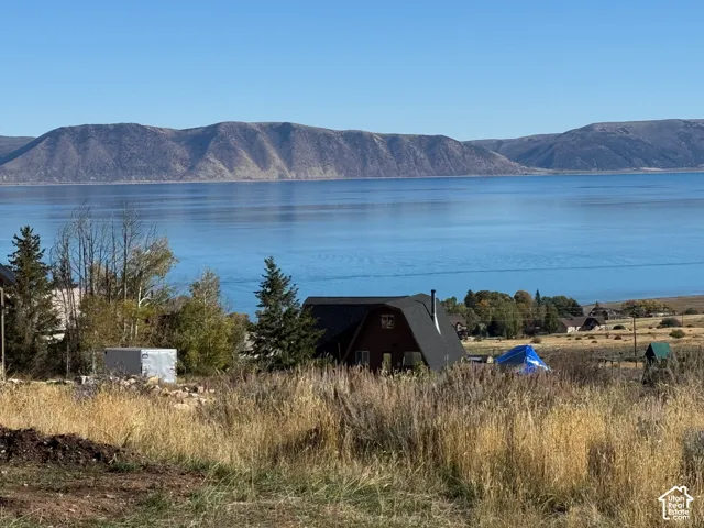 Exterior featuring a pitched roofline and natural landscape backdrop with expansive water and mountain scenery