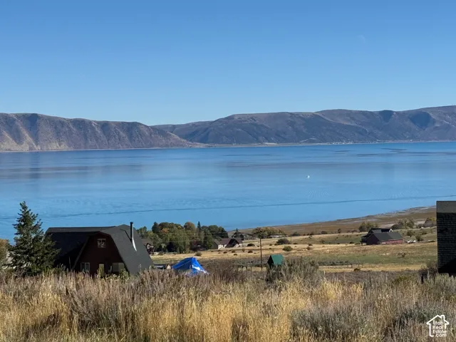 Expansive lot featuring water frontage, open terrain, and mountainous topography