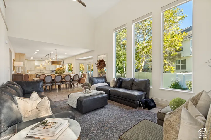 Vaulted ceilings, expansive floor-to-ceiling windows, recessed lighting, and wood-finish flooring