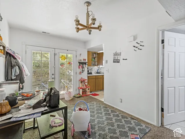 Unit B-Dining area with french doors in the back.  White door leads to 1/2 bath and laundry room.