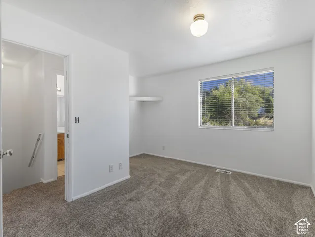 Unit A-Primary bedroom with entrance to full bath.