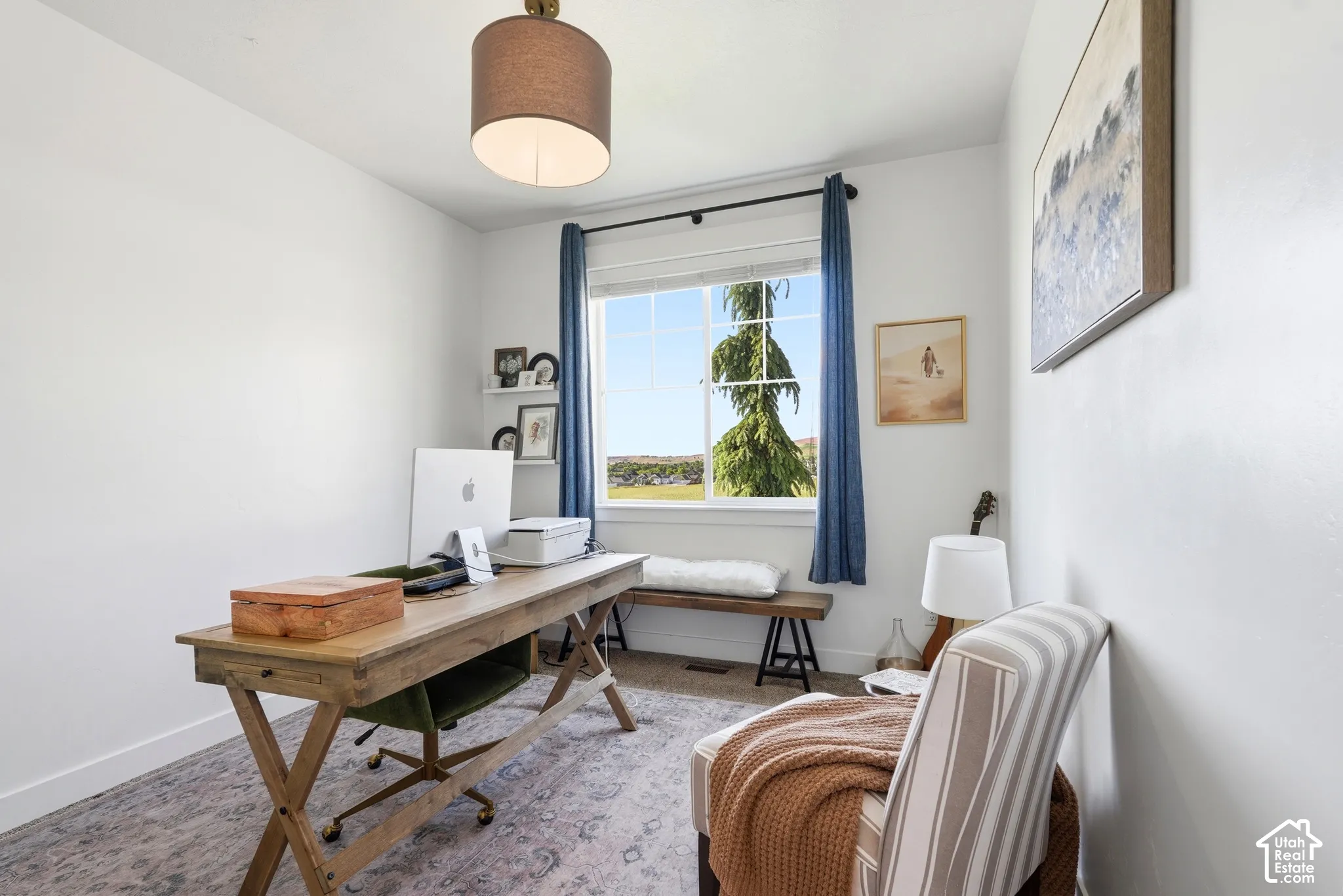 Neutral interior walls, carpet flooring, suspended drum pendant light fixture, and a single-pane sliding window