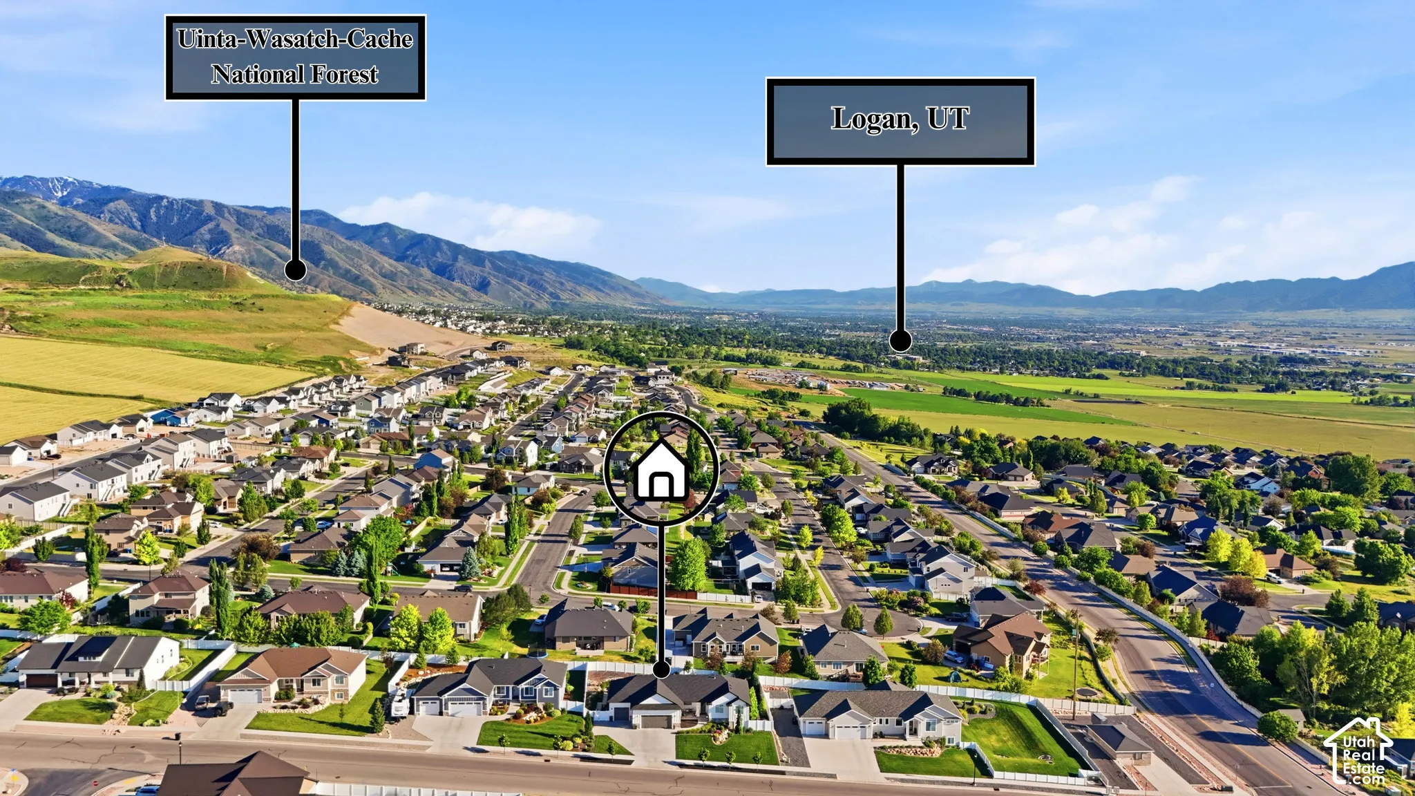 Aerial perspective of a residential property featuring mountain backdrops, expansive open space, and mature trees