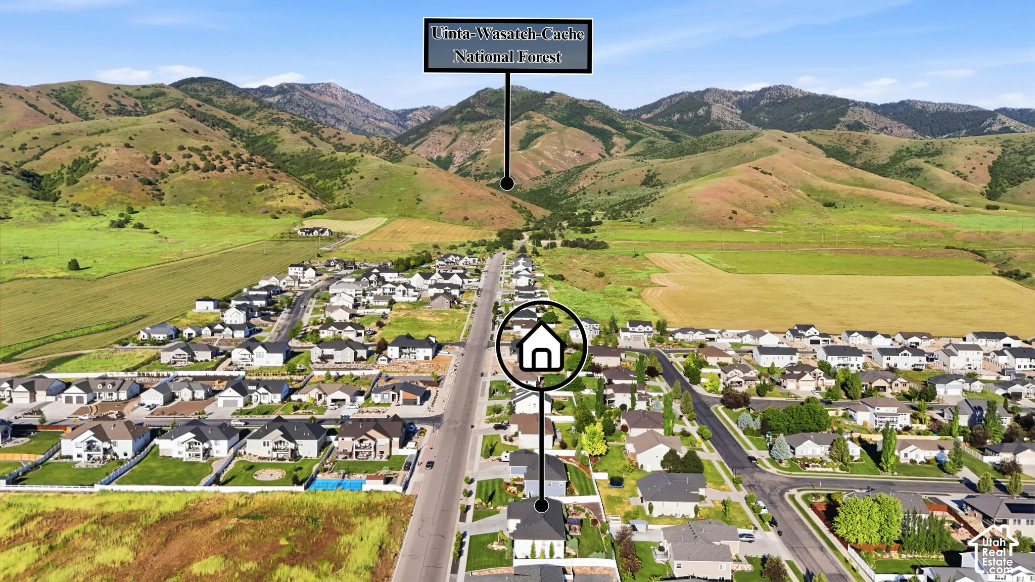 Aerial perspective of the residential property situated near the Uinta-Wasatch-Cache National Forest, featuring expansive mountainous scenery and open terrain