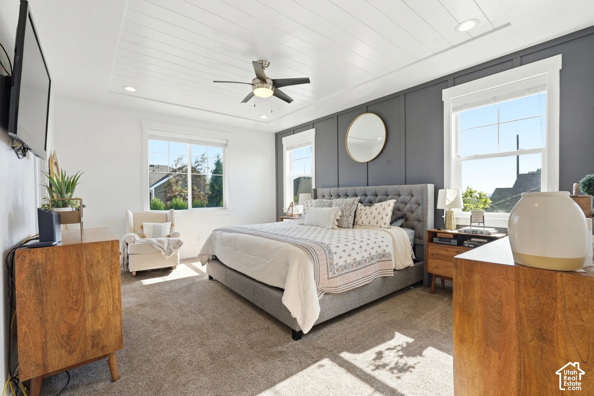 Room featuring a dark-toned vertical board-and-batten accent wall, plank-style ceiling detailing, recessed lighting, and a multi-blade ceiling fan