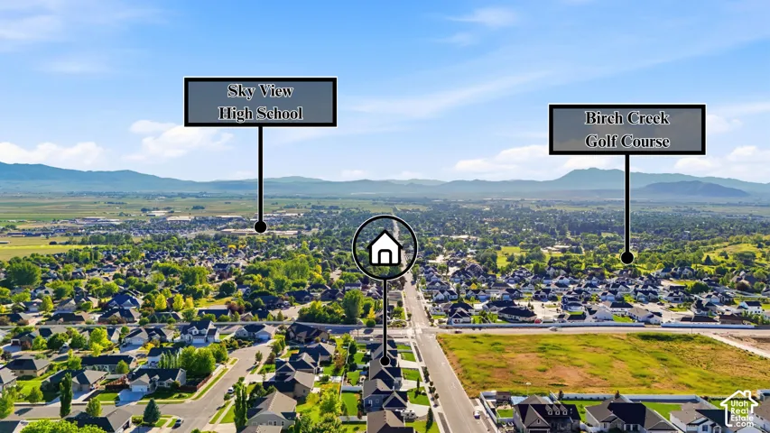 Aerial perspective of the residential property featuring mountainous surroundings and proximity to regional infrastructure and recreational golf course