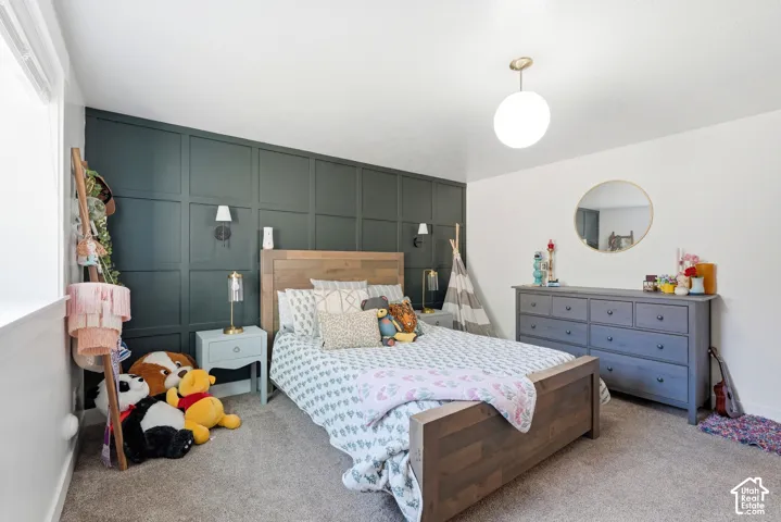 Dark-toned square wall molding, wall-mounted sconce lighting, spherical pendant light, and circular wall mirror