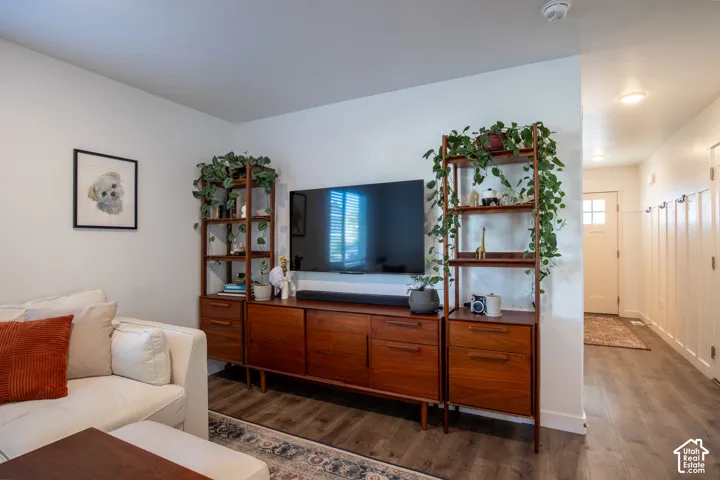 Wood-finish flooring, recessed lighting, and wall-mounted beadboard wainscoting